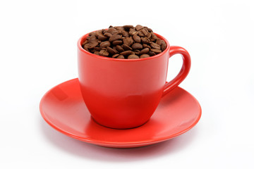 cup with beans coffee on saucer