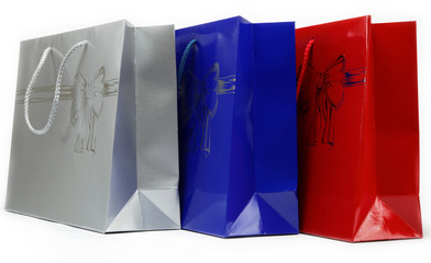 Red, blue and gray gift bags on a white background.