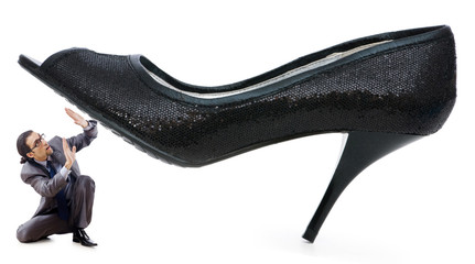 Woman domination concept with shoes and man