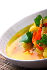 Fresh vegetable soup made of carrot, potato, leek, parsley, pea