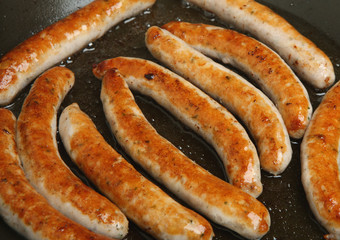 Sausages Frying in Pan