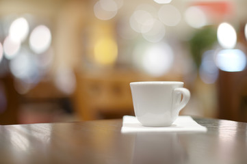 espresso coffee in thick white cup in a cafe, super shallow dof