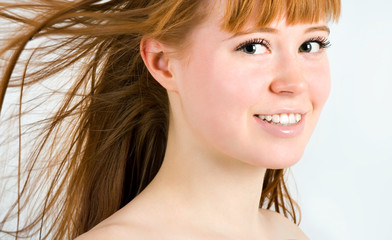 Naklejka premium Beautiful young red-haired woman with long beauty straight hair
