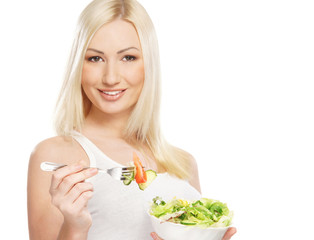 A young blond woman holding a fresh green salad