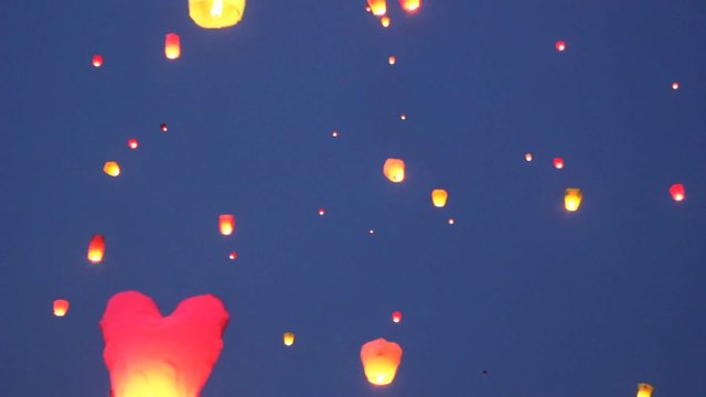 glowing  lanternes with burning flame inside flies