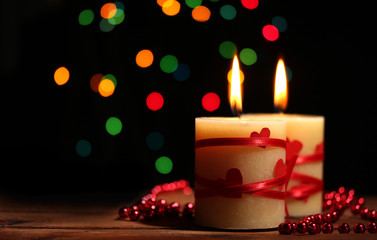Beautiful candles on wooden table on bright background