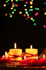 Beautiful candles on wooden table on bright background