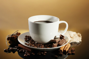 cup of coffee and beans, cinnamon sticks and chocolate