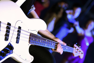 Naklejka premium Young guitar player performing in night club