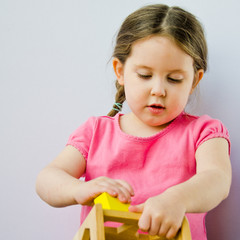 A lttle girl plays with blocks