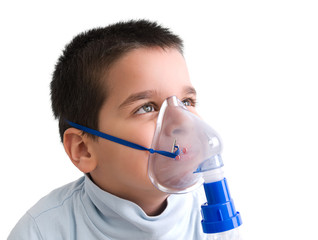 Close up image of a little boy with asthma using oxygen mask