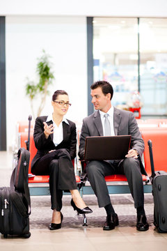 two business travellers waiting for flight at airport