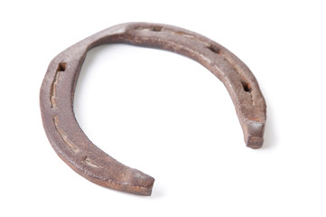 Close-up of an old, rusty horseshoe, isolated over white