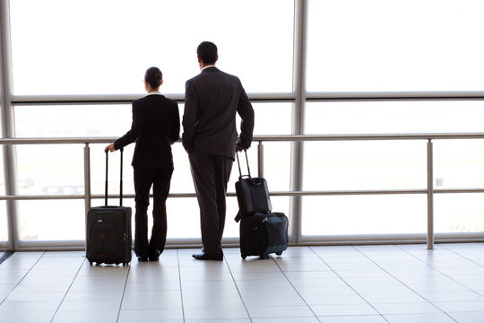silhouette of two businesspeople at airport