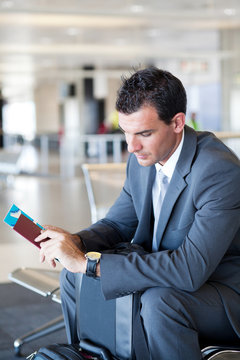 young businessman waiting for his flight in airport