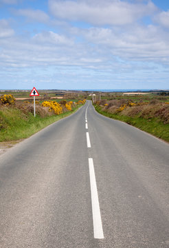 English Country Road With The Sea On The Horizon.