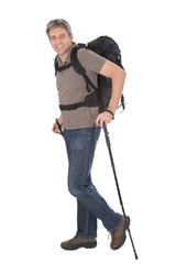 Senior man with backpack and hiking poles