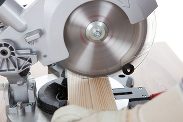 Worker cutting timber using circular saw