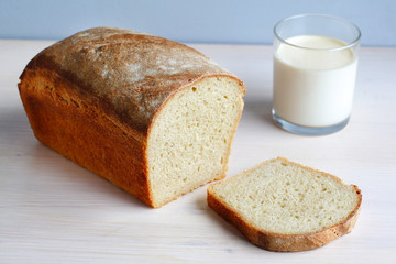 Sliced homemade cornbread with a glass of milk, breakfast
