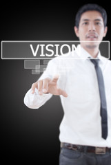 Businessman pushing Vision word on a touch screen interface.
