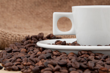 A cup of coffee on the background of coffee beans