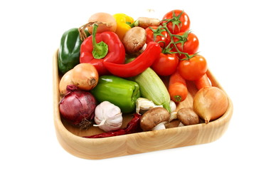 Vegetables for soup on wooden tray.