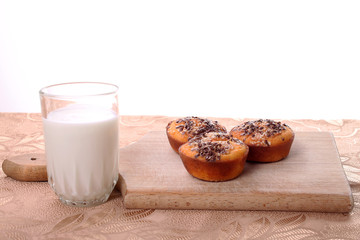 Corn muffins on a plate with a cup of yogurt