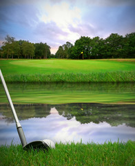 hitting golf ball over water hazard