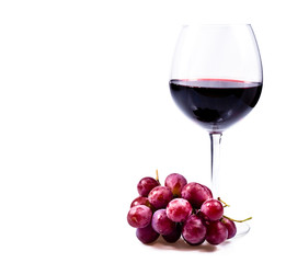 wine glass with red wine and grapes