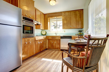 Kitchen with wood cabinets and chair.