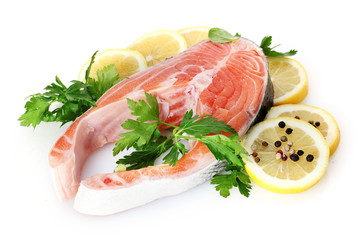 Red fish with lemon, parsley and pepper isolated on white.