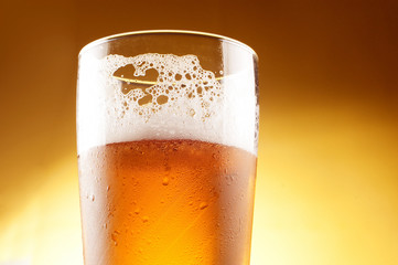 Glass of beer with froth close up