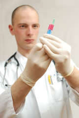 young male doctor holding vaccine in his hand