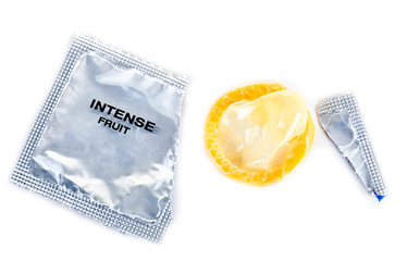 A condom with a broken package on a white isolated background