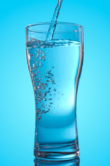 pouring water into a glass
