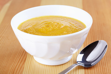 Pumpkin soup in white plate