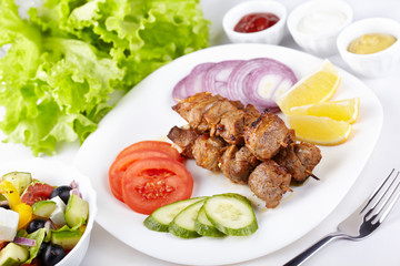 Kebab with fresh vegetables and greek salad