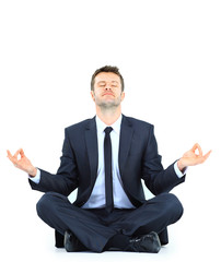 businessman meditating in yoga lotus pose on floor