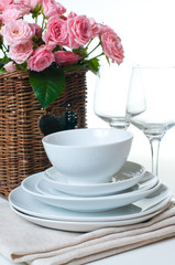 dishes, towels and a basket of flowers