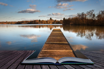 Fishing jetty on lake coming out of magic book pages