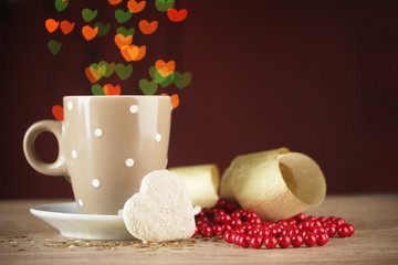 cup of coffee on wooden table on bright bokeh backdground
