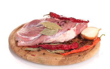 Raw meat and vegetables on a wooden board isolated on whitе