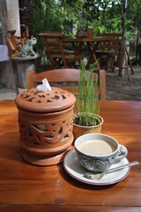 Cup of Coffee on the table in a morning garden
