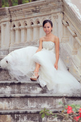 women in white dress bride sitting on stairway