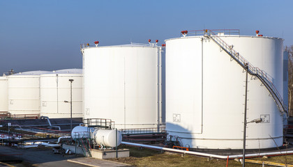 white tank in tank farm with blue sky