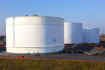 white tank in tank farm with blue sky