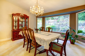 Dining room with large window in American house.