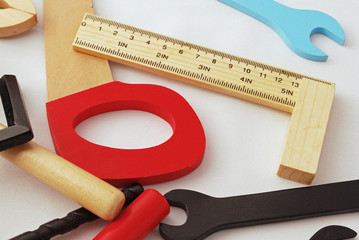 Composition of wood toy tools, white bakcground