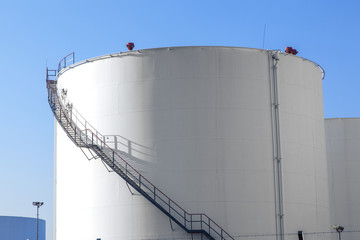 white tank in tank farm with blue sky