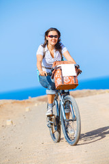 Fototapeta premium Woman on bike outdoors smiling